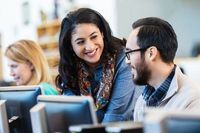 Two People Talking in Front of Computer.jpeg