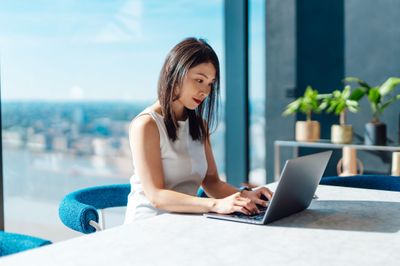 woman reading laptop at conferance table.jpg