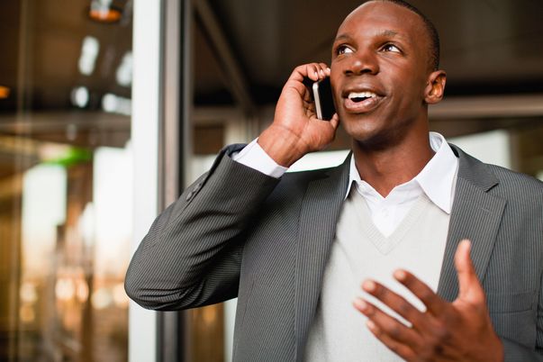 man_in_suit_holding_mobile_phone_to_ear.jpg